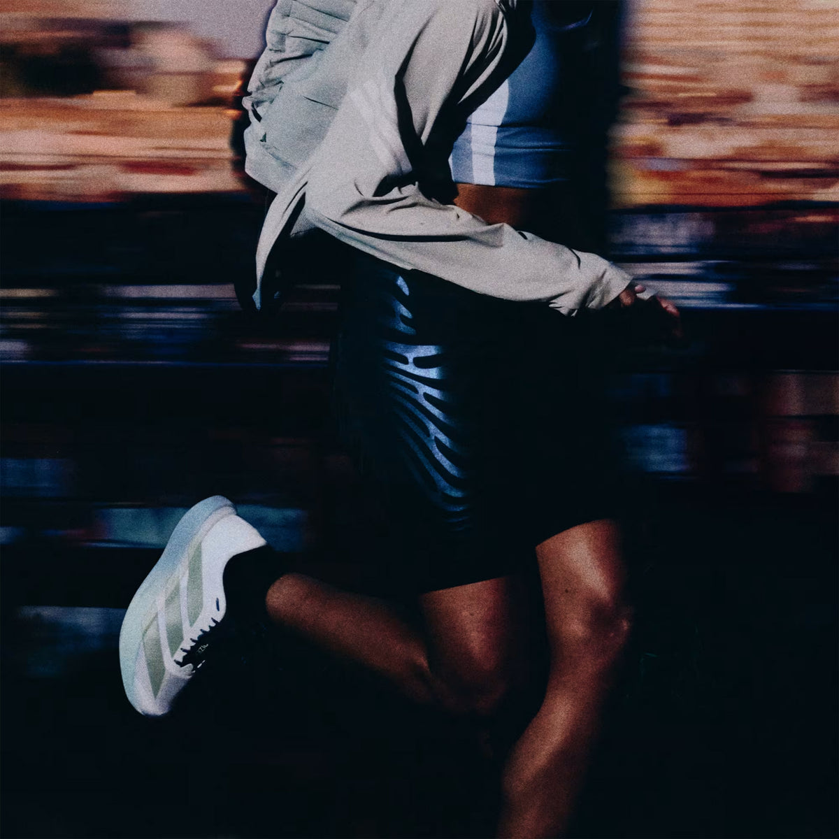 Women's adidas Adizero EVO SL Running Shoes Off White Ice Gold Metallic Granite worn by female runner in motion showing LIGHTSTRIKE PRO foam energy return with Continental rubber traction during tempo running