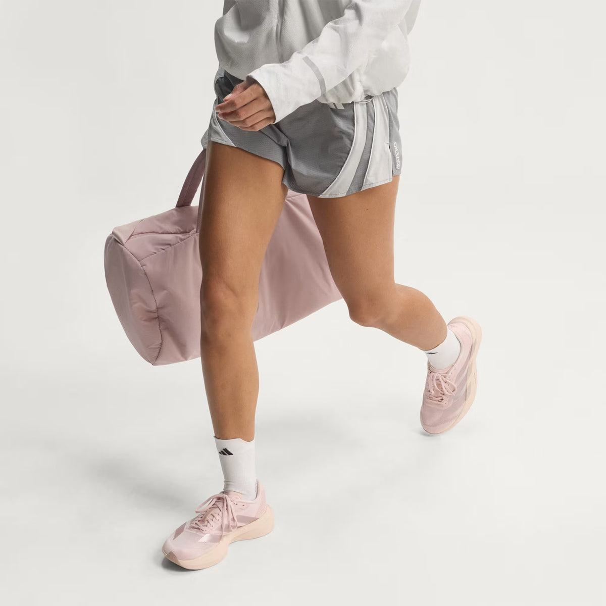 Women's adidas Adizero EVO SL Running Shoes Wonder Quartz Grey Wonder Taupe side view on female runner showing racing-inspired design with LIGHTSTRIKE PRO foam for running performance and lifestyle versatility