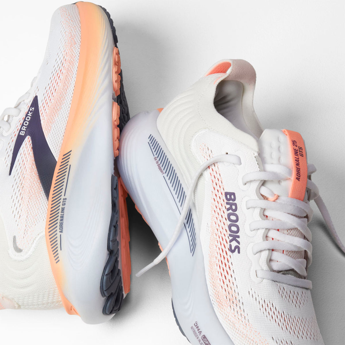 Brooks Adrenaline GTS 25 women's running shoe in Oyster Mushroom / Peach / Grape — angled side view showing oyster mushroom engineered mesh upper, GuideRails support sidewalls and peach DNA LOFT cushioning midsole stack