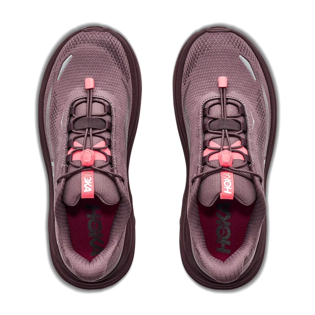 Two athletic shoes in smoky quartz and deep mauve with pink pull-tab laces are viewed from above on a white background. The insoles are dark red with Hoka branding visible inside each shoe, highlighting the new Women’s Clifton 11 GORE-TEX Running Shoes by Hoka—designed to keep your feet dry and comfortable in any weather.