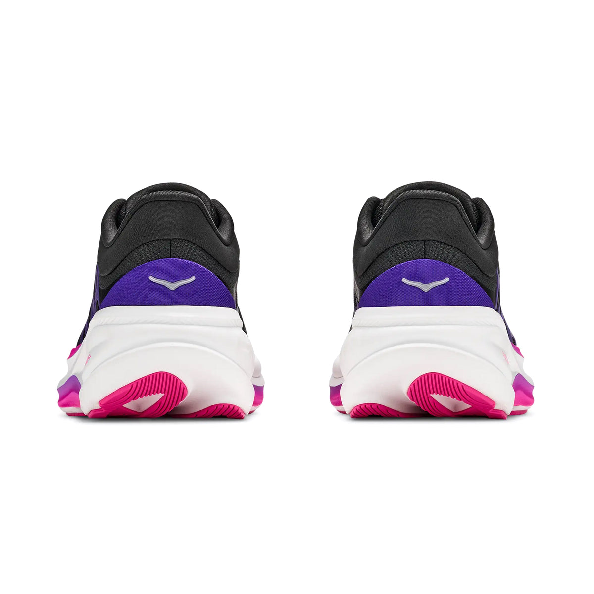 Rear view of a pair of Hoka Women’s Clifton Pro Running Shoes in Carbon Black and Cosmic Purple, showcasing black, purple, and white uppers, white midsoles, and pink outsoles. Both sneakers display a small white logo on the heel tab, echoing the streamlined design characteristic of HOKA Clifton Pro models.