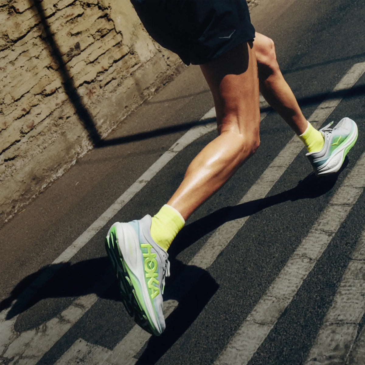 HOKA Clifton Pro Running Shoes on runner in motion showing PROGLIDE+ series SCF foam with aggressive MetaRocker geometry for lively smooth transitions during daily road running