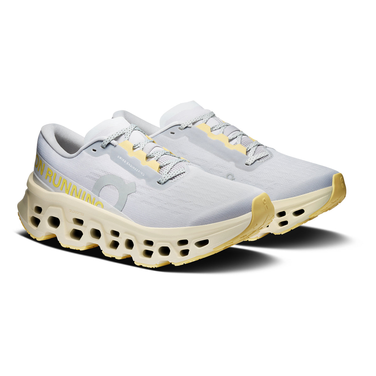 Women's On Cloudmonster 3 Running Shoes Glacier Pollen angled side view of pair showing triple-layer CloudTec foam with Helion cushioning, enhanced rocker shape and compressed rubber outsole for maximum cushioned responsive daily running