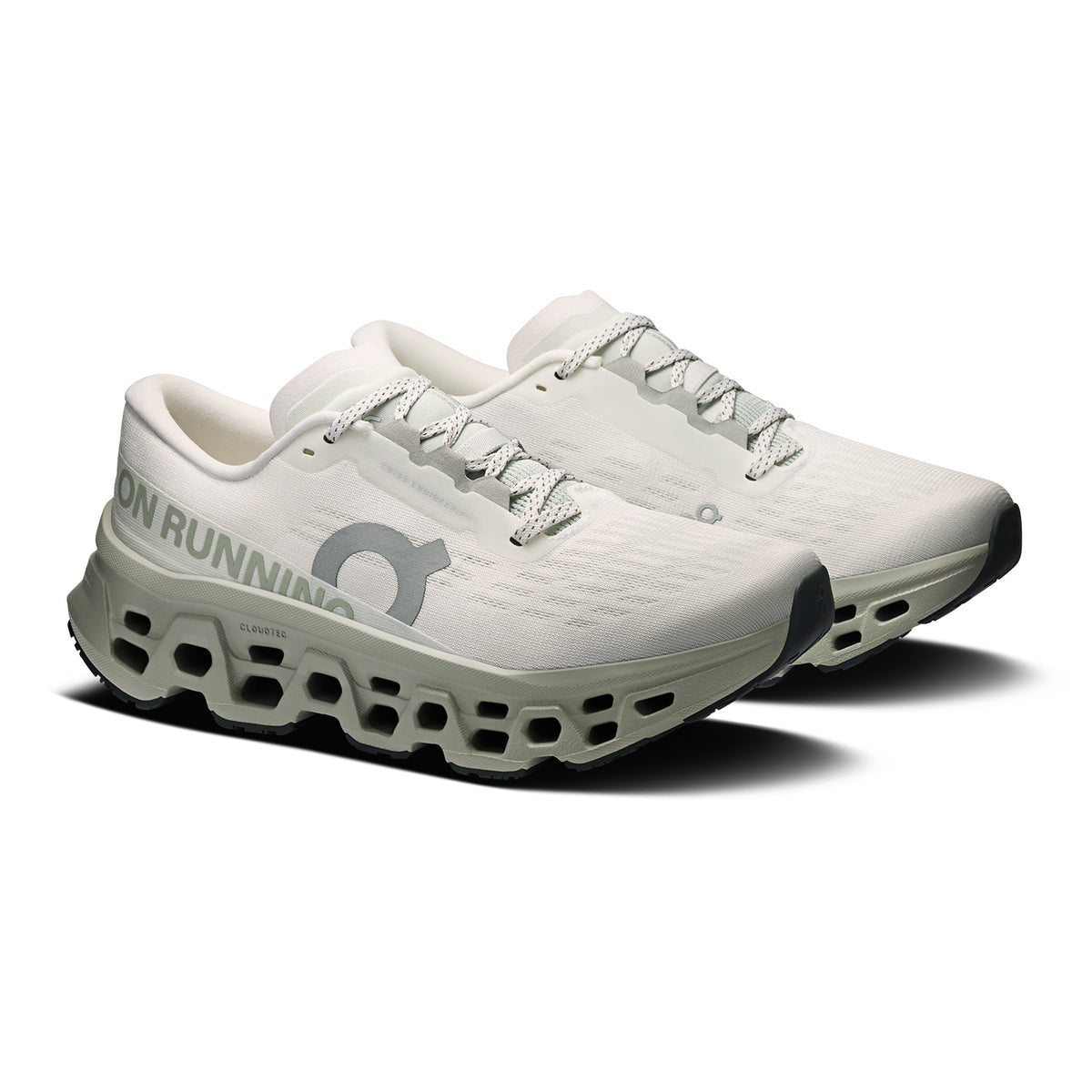 On Cloudmonster 3 women's running shoe in Ivory / Tin — angled side view showing ivory engineered knit upper, Speedboard® profile, enhanced rocker geometry and tin grey triple-layer CloudTec® Helion™ foam midsole stack