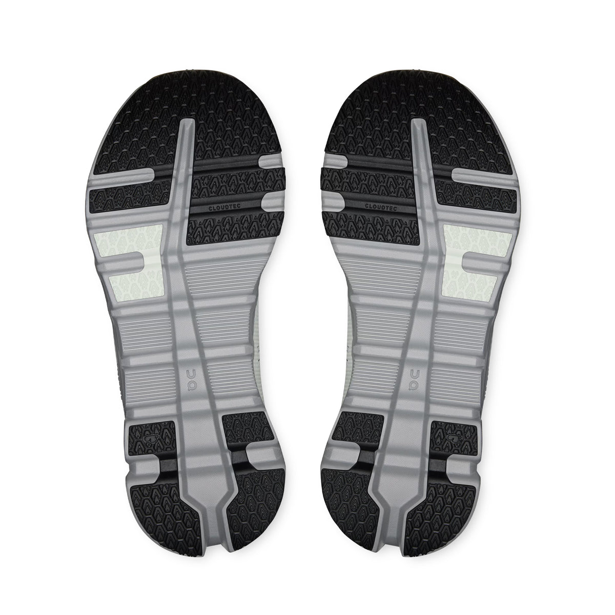 A pair of Women’s Cloudrunner 2 Waterproof Running Shoes by On (Iceberg / Alloy) shown with the soles facing upward, displaying a pattern of black and gray rubber with textured tread and horizontal grooves for traction—engineered with Helion™ superfoam cushioning to enhance your run.