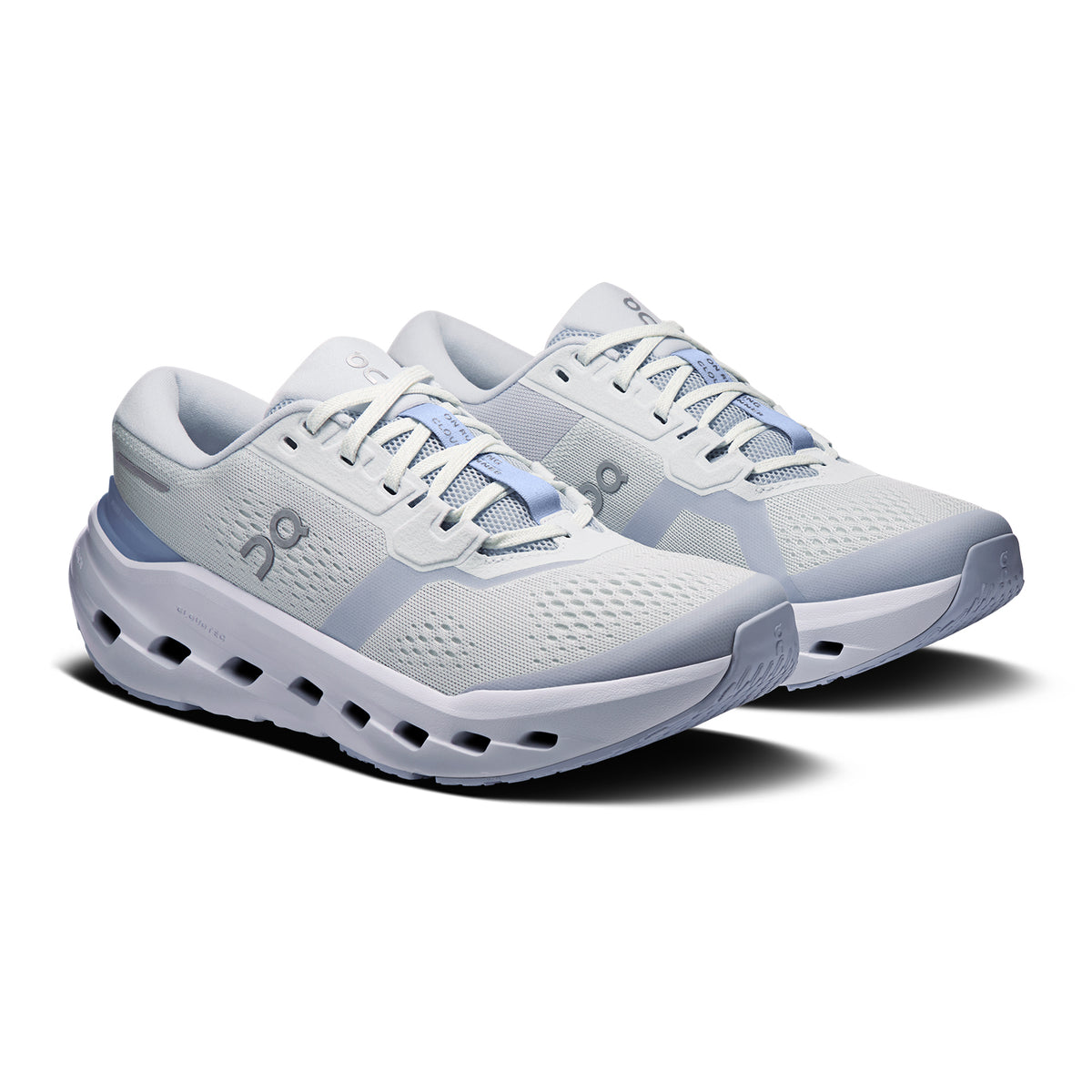 A pair of light gray and white athletic running shoes with mesh uppers, distinct cushioned soles, light blue accents, and lace-up closures, positioned side by side on a white background.