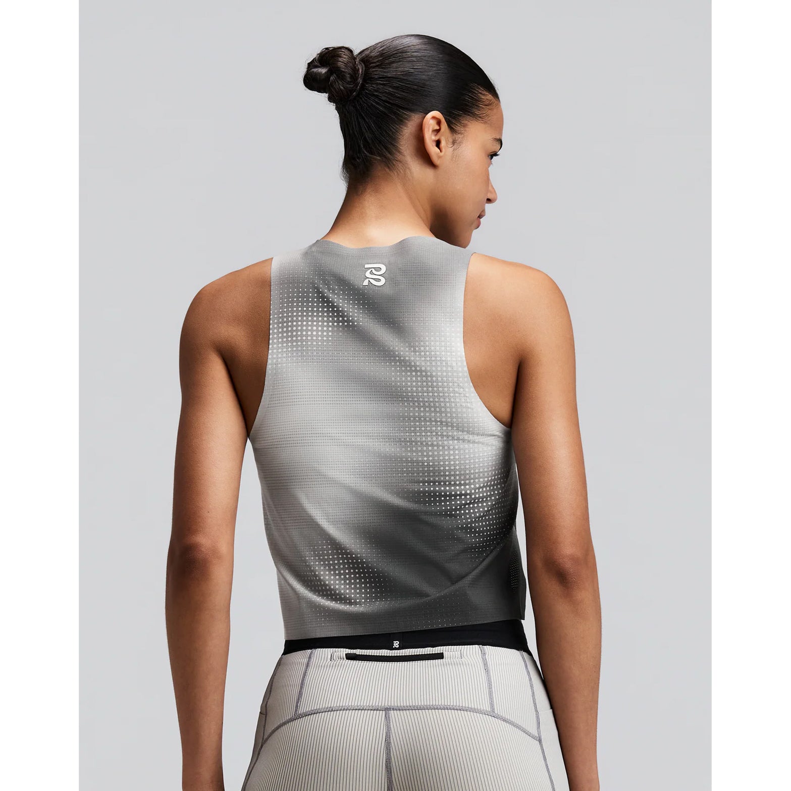 Women's Bandit CoolGrid Race Singlet Slate Multi back view on female runner showing bonded seam construction with side slits and two-tone reflective branding for low-light visibility