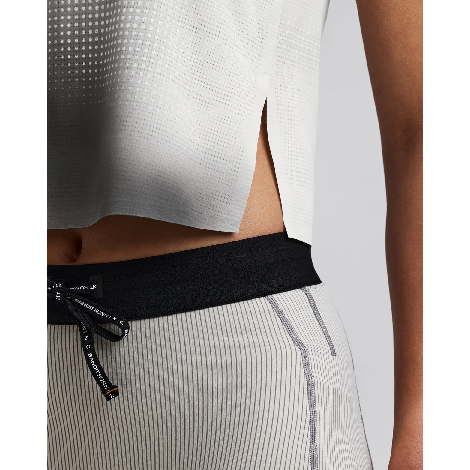 Women's Bandit CoolGrid Race Singlet Slate Multi close-up of side slit showing mobility-enhancing construction with bonded seam finish for unrestricted movement during racing and tempo efforts