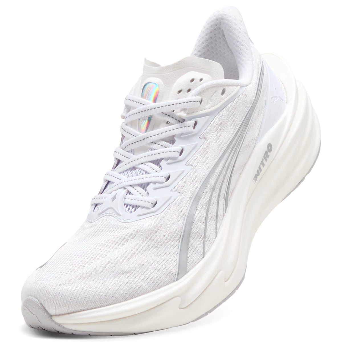 A white athletic running shoe with mesh upper, silver accents, and a thick, curved sole. The shoe features an iridescent logo on the tongue and subtle branding on the side.