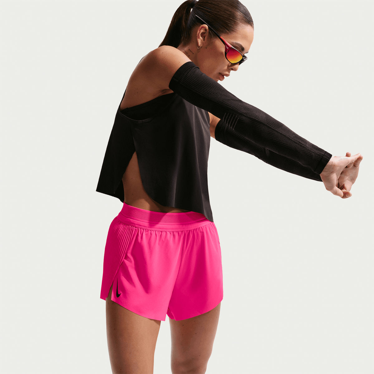 Women's Nike Dri-FIT Aeroswift ADV Mid-Rise 3 Inch Running Shorts Hyper Pink Black side view on female runner showing mid-rise 3-inch inseam with Dri-FIT ADV moisture management and breathable construction for racing and tempo runs