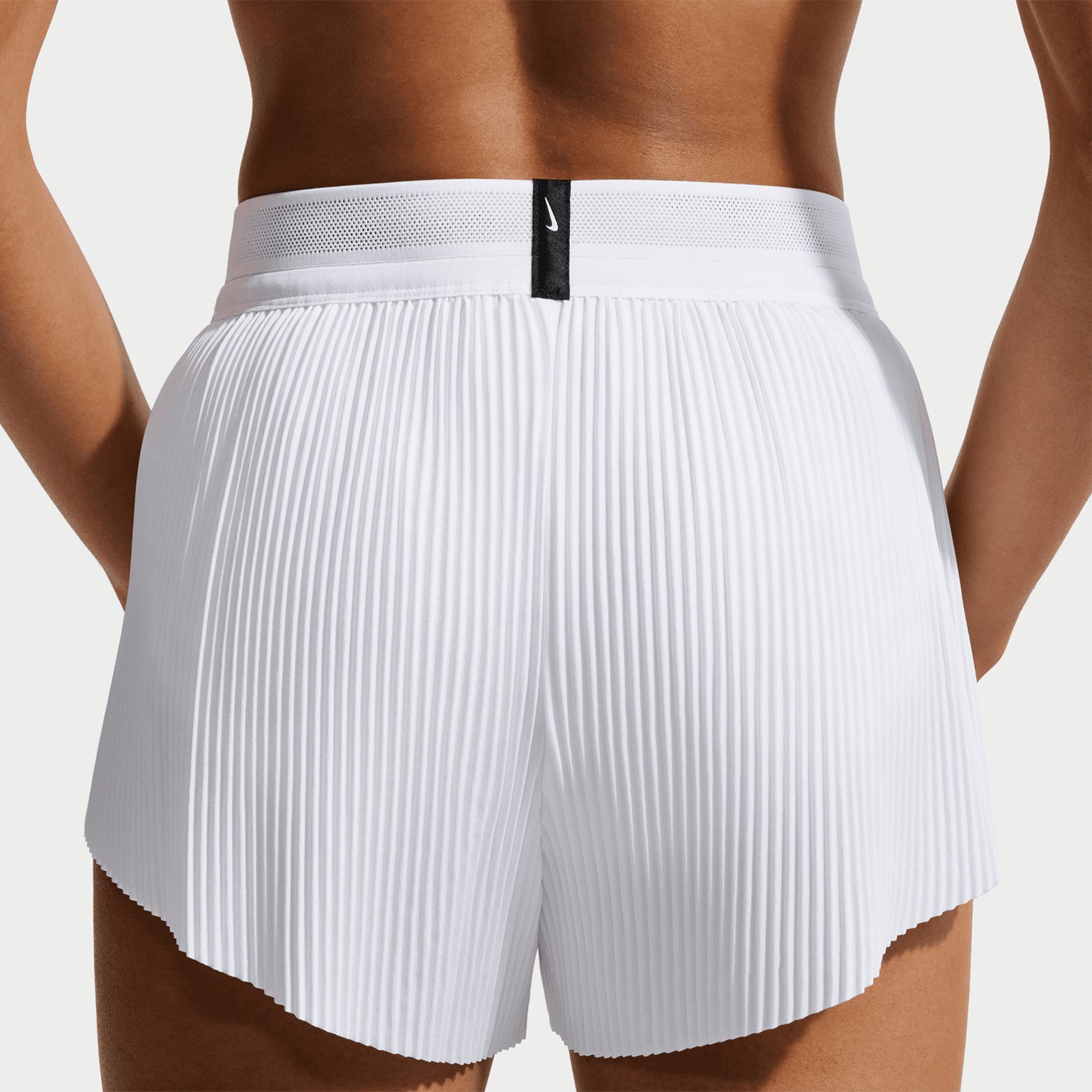 Women's Nike Dri-FIT Aeroswift ADV Mid-Rise 3 Inch Running Shorts White Black back view on female runner showing 3-inch inseam with breathable racing construction and moisture management