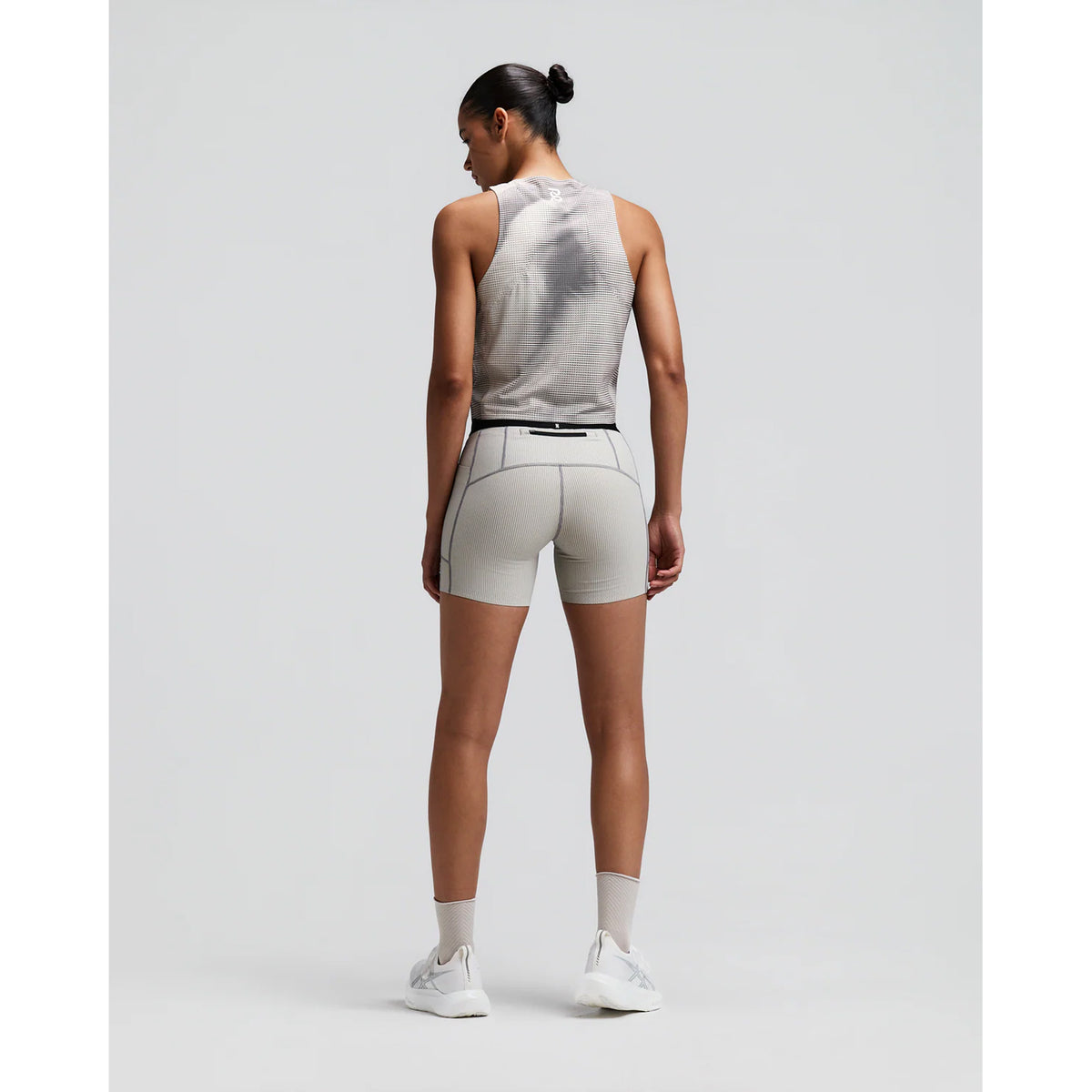 Women's Bandit GeoMesh Race Singlet Slate Plaster back full body view on female runner showing bonded construction with GeoMesh four-way stretch and moisture-wicking fabric for breathable race day performance