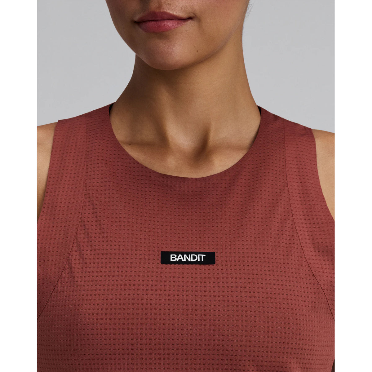 Women's Bandit GeoMesh Race Singlet Mahogany close-up front showing logo detail and moisture-wicking four-way stretch GeoMesh fabric