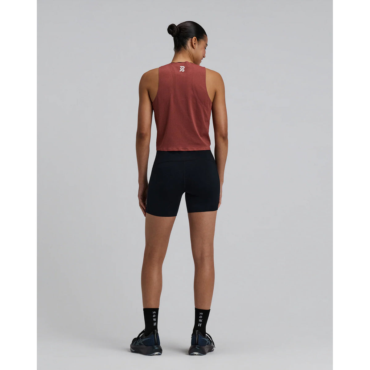 Women's Bandit GeoMesh Race Singlet Mahogany full body back view on female runner showing ultra-breathable GeoMesh knit with seamless featherweight finish