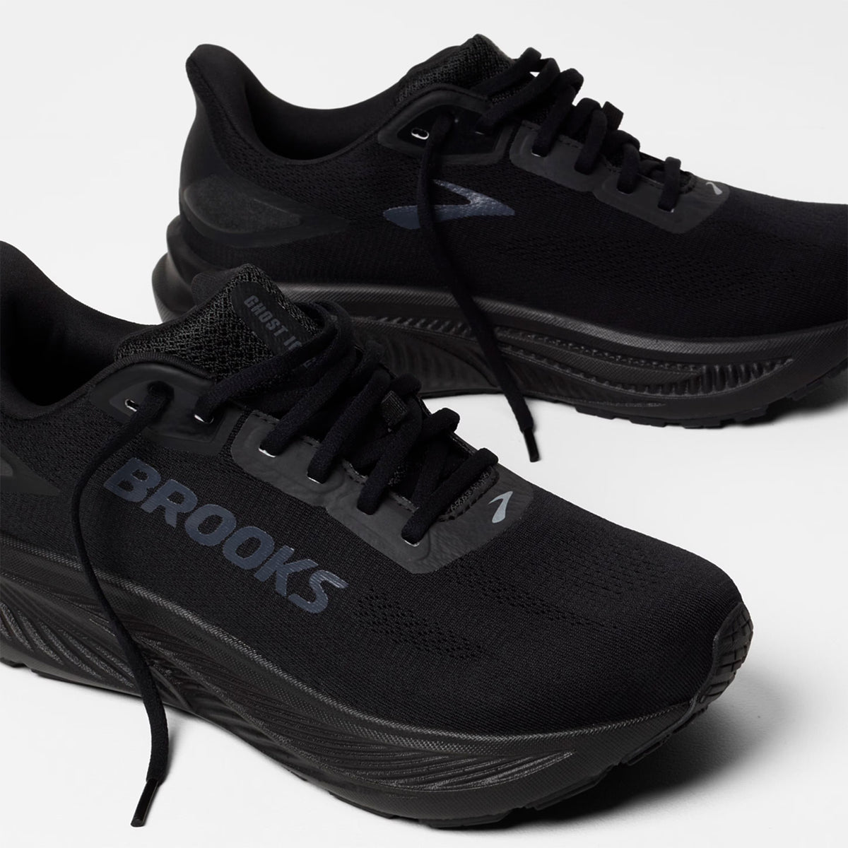A pair of black Brooks running shoes with thick soles and the BROOKS logo on the side, displayed on a white background.