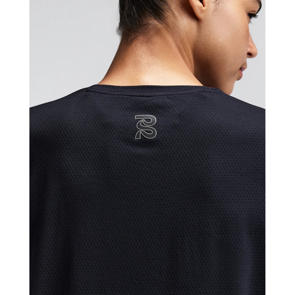 Women's Bandit Micromesh Cropped Run Tee Black close-up of back showing fast-drying Micromesh fabric with sweat-wicking airflow construction for sustained running efforts