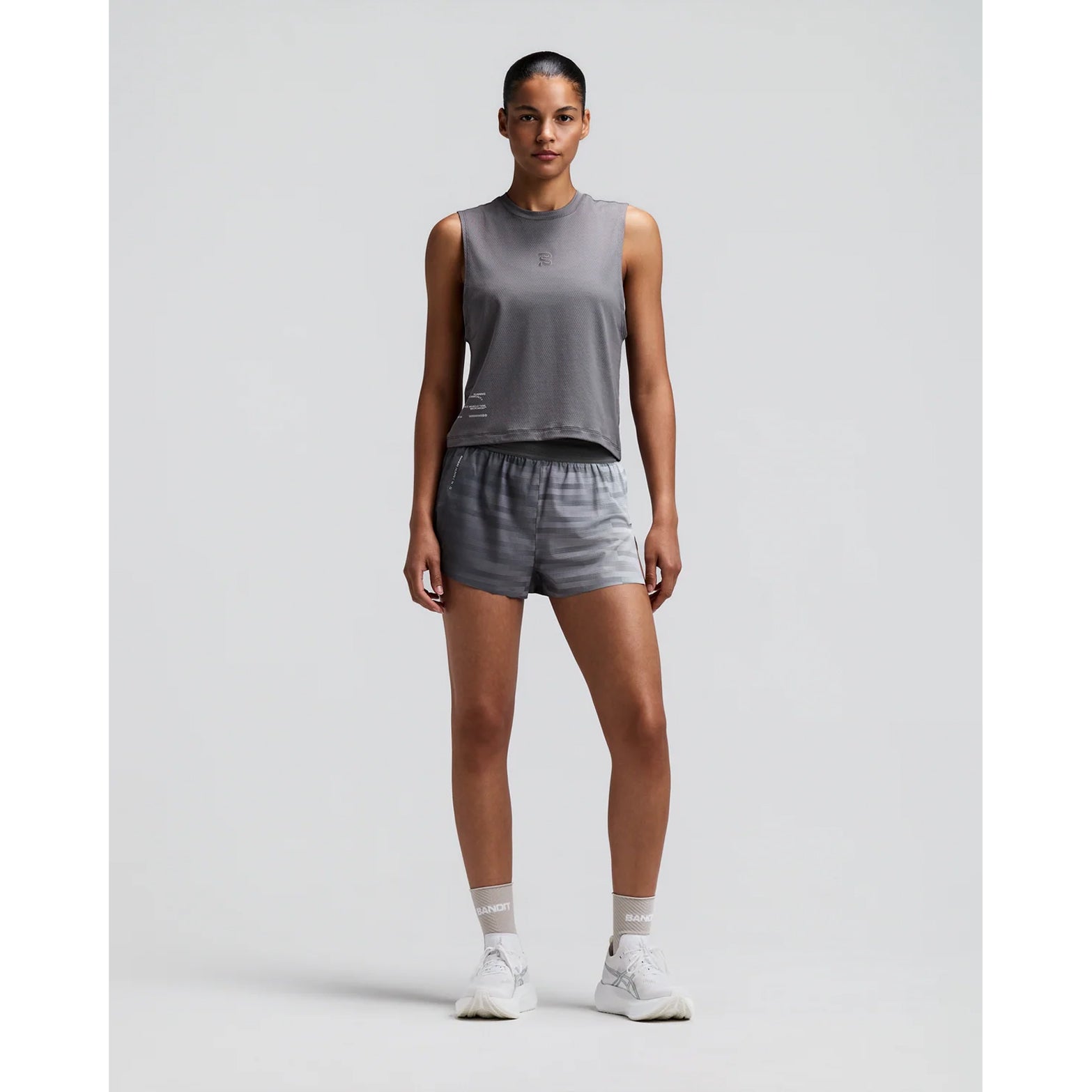 Women's Bandit Micromesh Run Tank Slate front full body view on female runner showing relaxed tank fit with breathable Micromesh moisture-wicking for training and everyday running