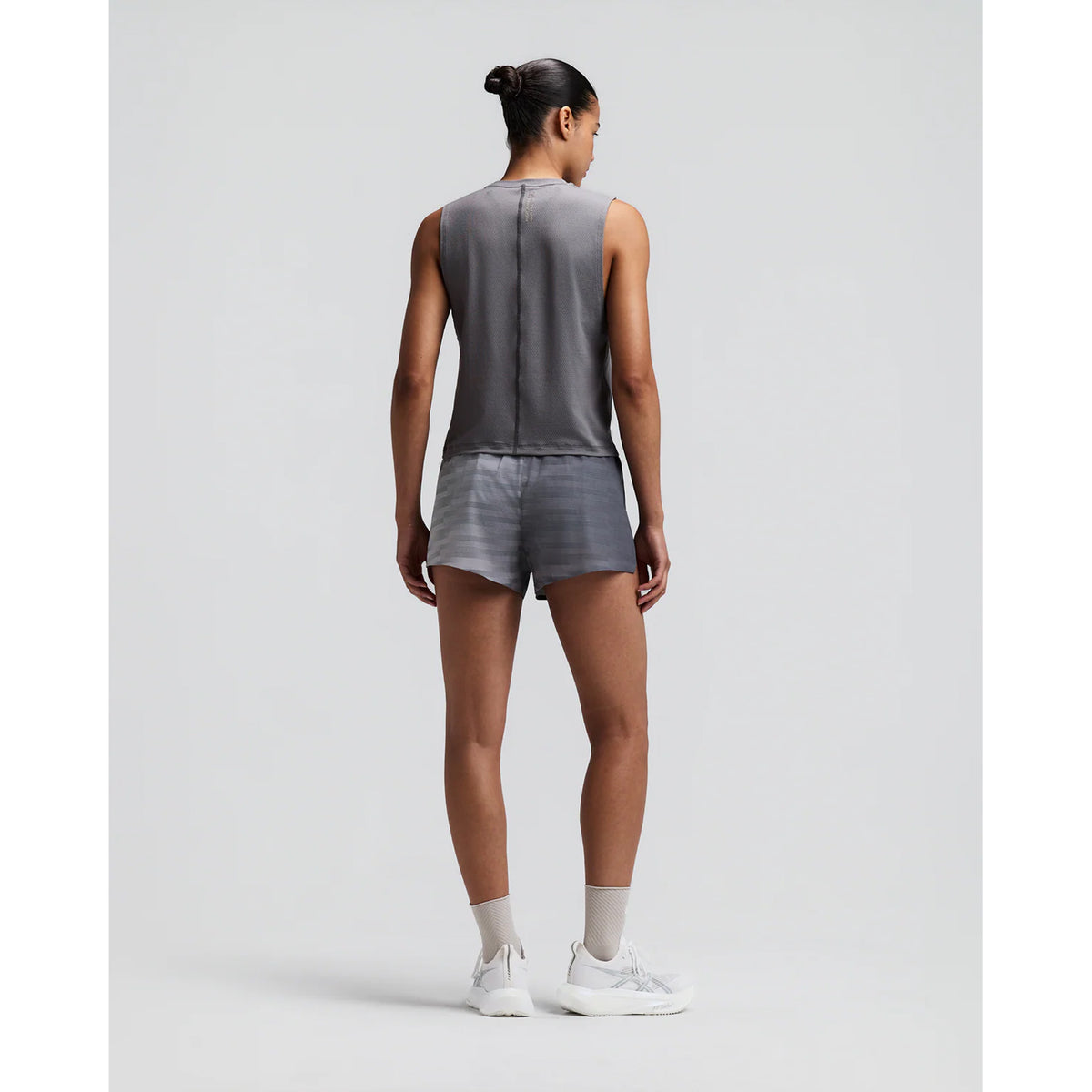 Women's Bandit Micromesh Run Tank Slate back full body view on female runner showing relaxed tank construction with fast-drying Micromesh fabric for comfortable running and training