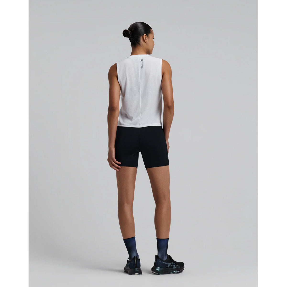 Bandit Micromesh Run Tank women's in White — full body back view worn on model showing sleeveless relaxed silhouette, flatlock seam at centre back and Micromesh™ breathable fabric construction