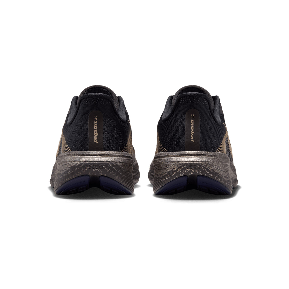 A rear view of a pair of Nike Women’s Pegasus 42 Keely Hodgkinson Running Shoes in Black, Pitch Blue, Blackened Blue, and Blur showcases the athletic shoes’ black uppers, brown mesh sides, and thick gray soles. Reminiscent of renowned Pegasus models featuring Air Zoom cushioning for comfort, these shoes offer both style and support. The Nike logo is visible on the back of each shoe.