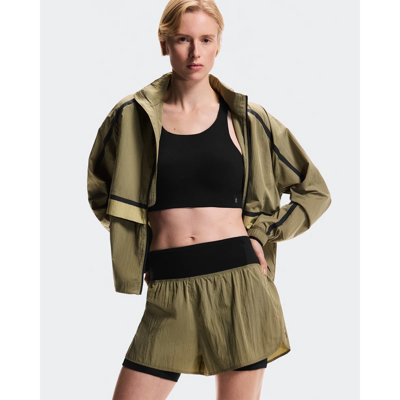 Women's On Performance Volt Shorts Safari front view on female runner showing lightweight iridescent outer fabric with moisture-wicking On DryTec inner layer