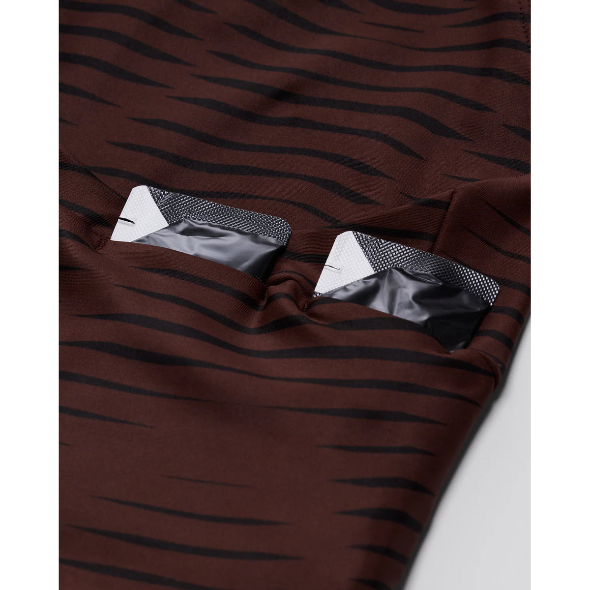 Women's Bandit Stamina Race Crop Organic Stripe Cacao close-up of 4 gel pockets showing sweat-proof storage designed to disappear when running