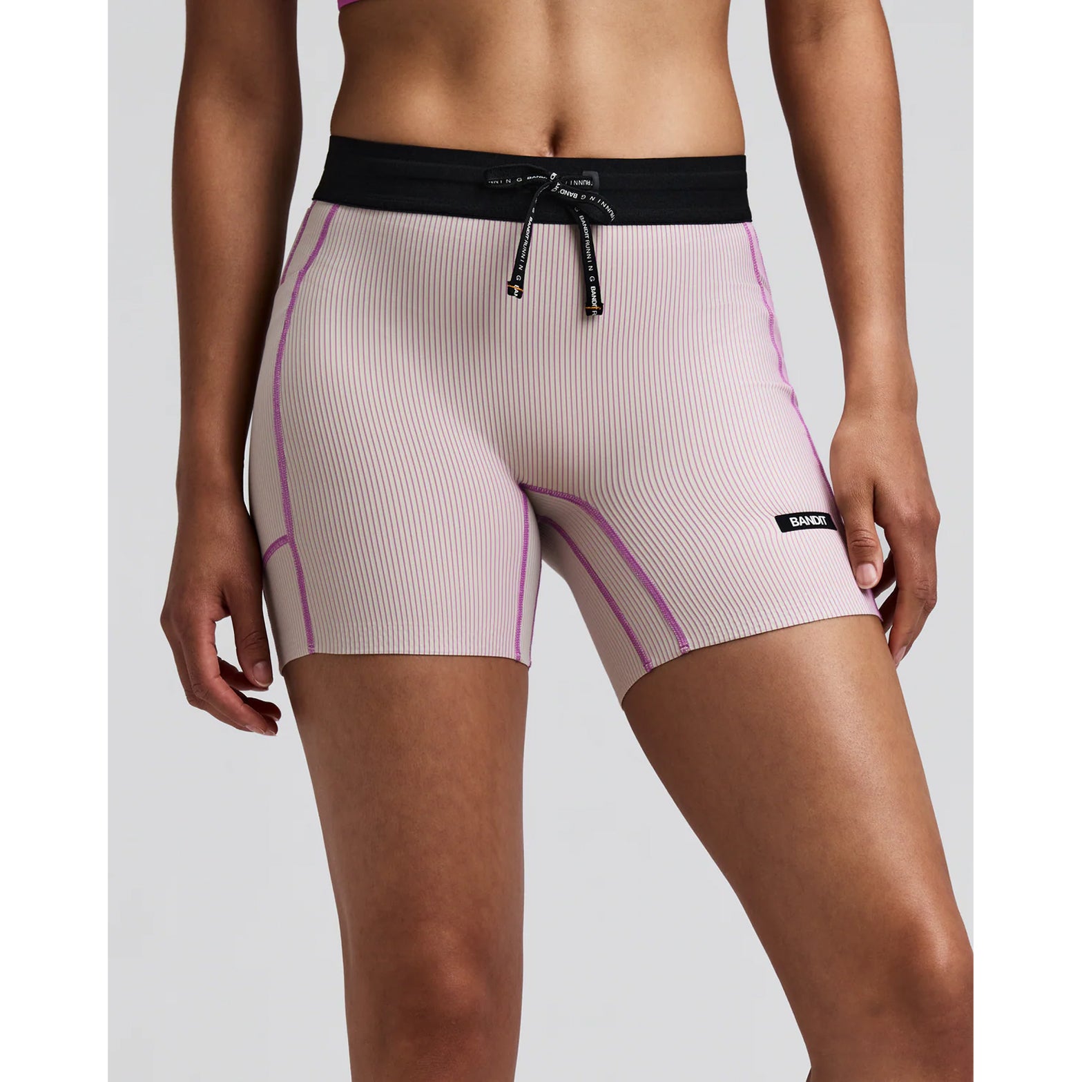 Women's Bandit Striped Cadence 5 Inch Compression Shorts Plaster Orchid front view on female runner showing ultra-compressive Striped Cadence ribbed knit with custom anti-chafe waistband for race day performance
