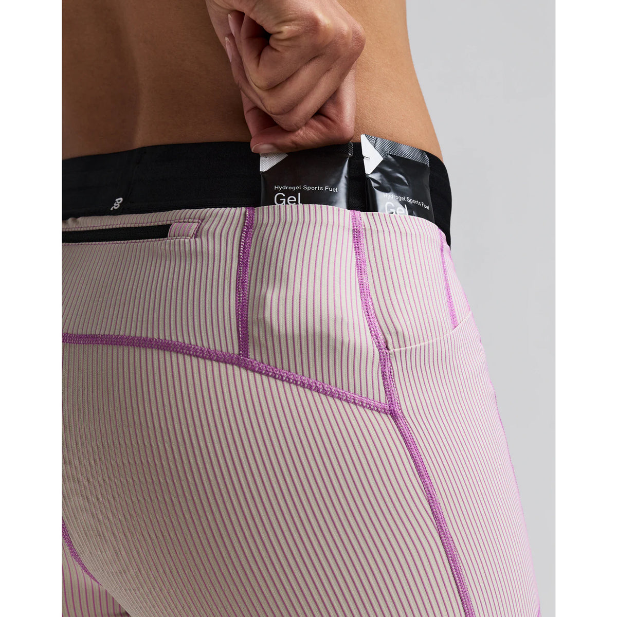 Women's Bandit Striped Cadence 5 Inch Compression Shorts Plaster Orchid close-up of gel pocket showing secure dedicated nutrition storage with zero-bulk design for race day fuelling without bounce
