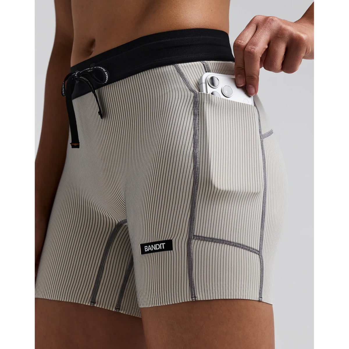 Women's Bandit Striped Cadence 5 Inch Compression Shorts Plaster Slate close-up of side phone pocket showing waterproof liner for sweat protection with secure hidden storage for race day essentials without bounce