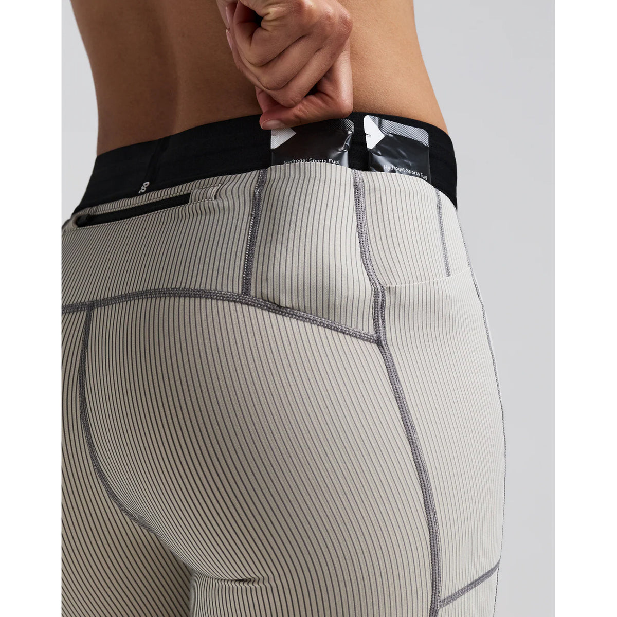 Women's Bandit Striped Cadence 5 Inch Compression Shorts Plaster Slate close-up of gel pocket showing secure dedicated nutrition storage with zero-bulk design for race day fuelling without bounce