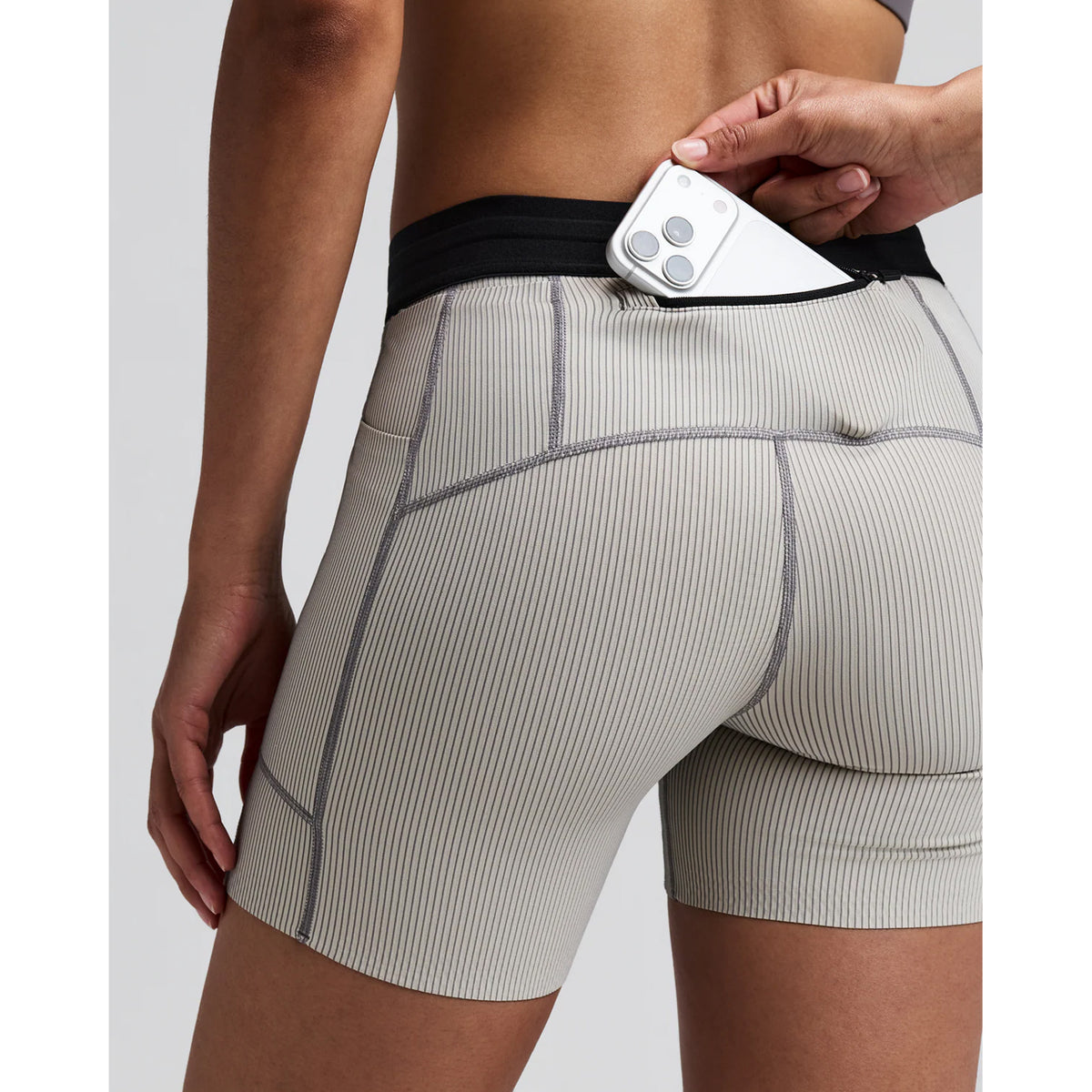 Women's Bandit Striped Cadence 5 Inch Compression Shorts Plaster Slate close-up of pocket system showing three waterproof phone pockets and two gel pockets with zero-bulk design for race day essentials