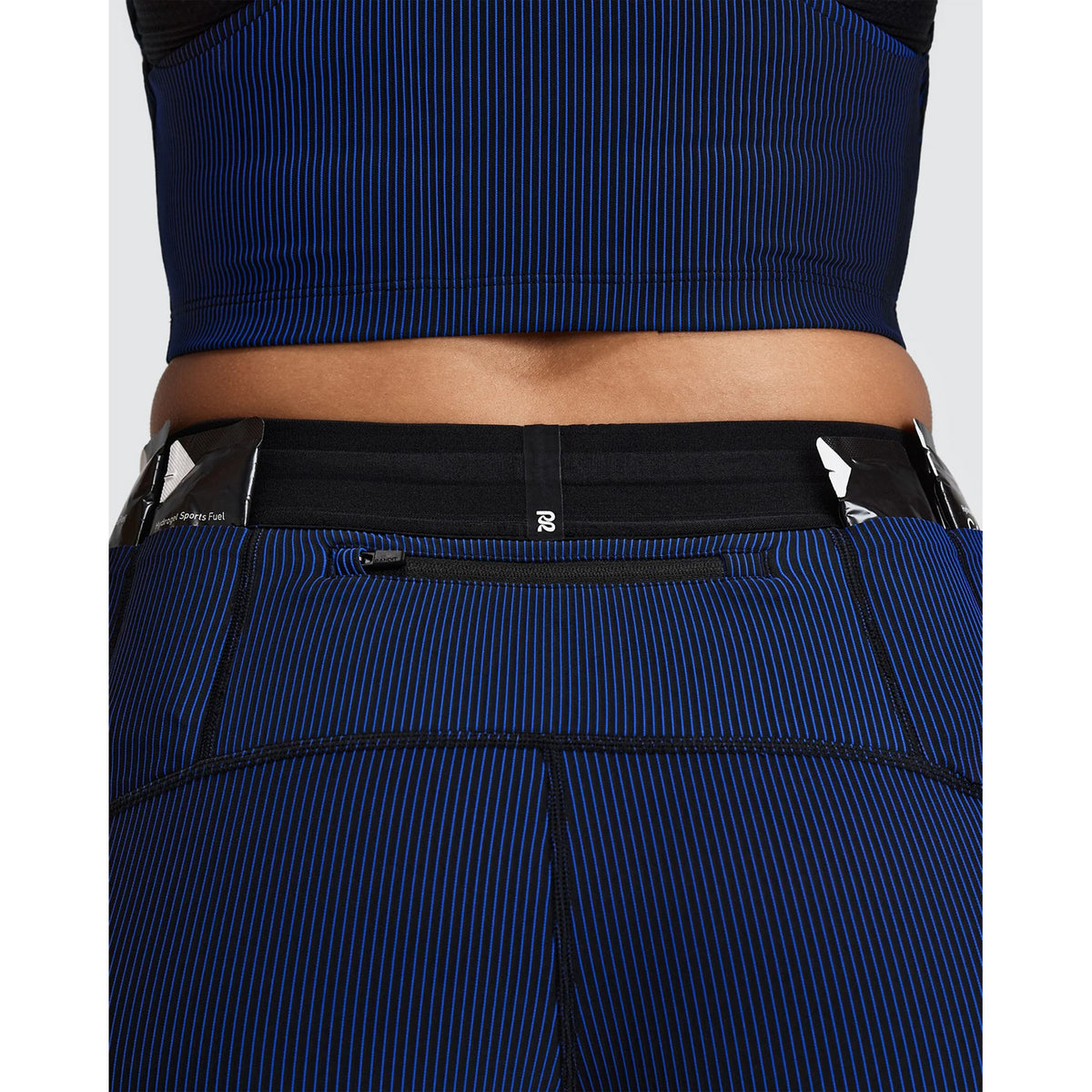 Close-up of the back of Women’s Striped Cadence 5″ Compression Shorts Black / Bauhaus Blue, highlighting a zippered waistband pocket on the blue and black ultra-compressive performance shorts.