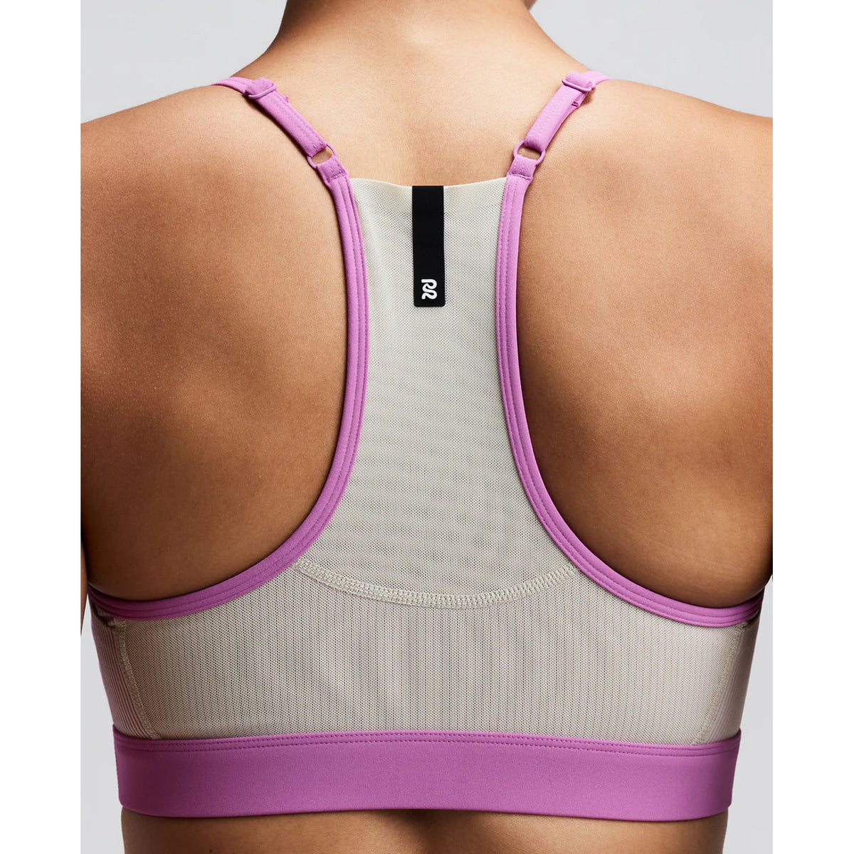 Women's Bandit Striped Cadence Strappy Bra Plaster Orchid close-up of pocket system showing gel pockets under each arm and waterproof centre back phone pocket with zero-bulk design for race day essentials