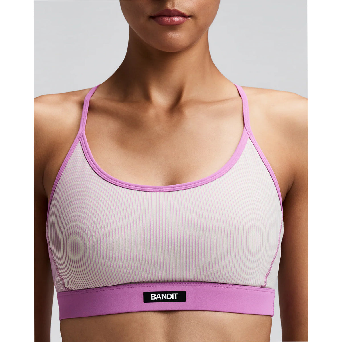 Women's Bandit Striped Cadence Strappy Bra Plaster Orchid close-up of front showing Striped Cadence ribbed compression with Bandit branding at centre chest and Vanisher band at hem