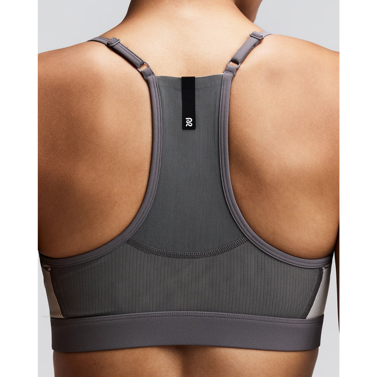 Women's Bandit Striped Cadence Strappy Bra Plaster Slate close-up of back showing Powermesh panel with waterproof centre back phone pocket and reflective details for running visibility