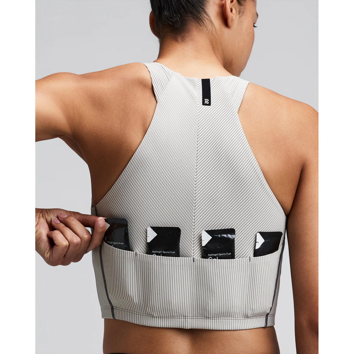 Women's Bandit Striped Cadence Zip Front Race Crop Plaster Slate close-up of pocket system showing three waterproof phone pockets and four gel pockets with zero-bulk design for race day essentials