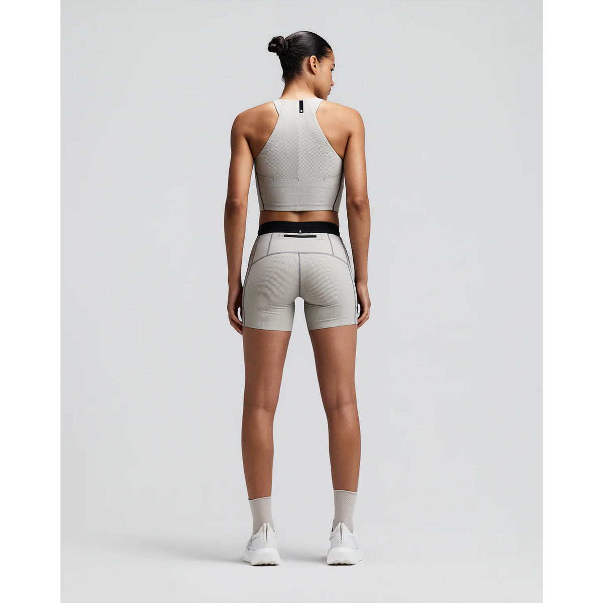 Women's Bandit Striped Cadence Zip Front Race Crop Plaster Slate back full body view on female runner showing angular racer back with silicone patch and Striped Cadence ribbed compression for race day performance