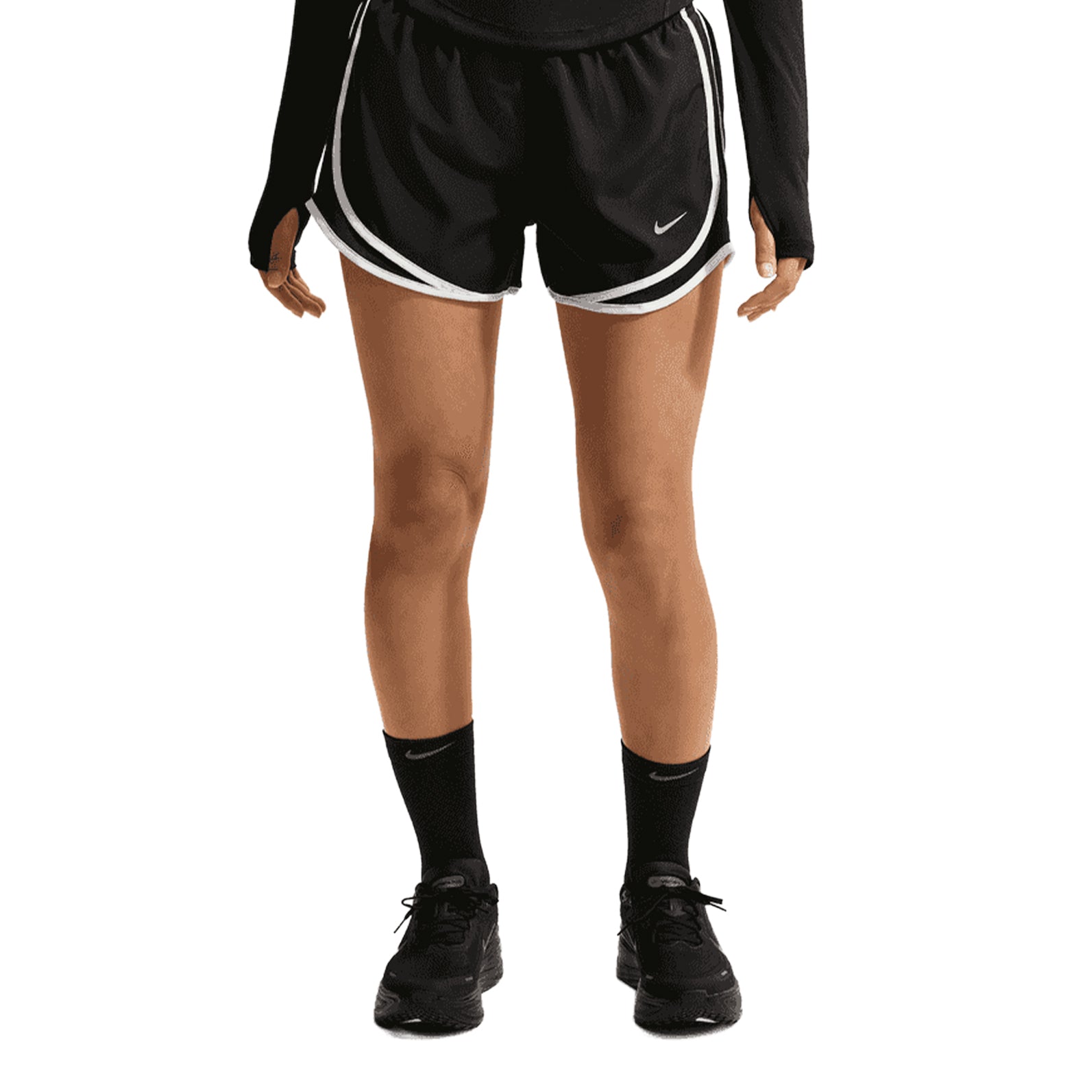 A person is wearing Nike Women’s Tempo Dri-FIT Mid Rise Running Shorts in Black/Black/White, which feature mesh ventilation for enhanced breathability, along with a black long sleeve shirt, black socks, and black sneakers. The person’s hands are at their sides and their full face is not visible.