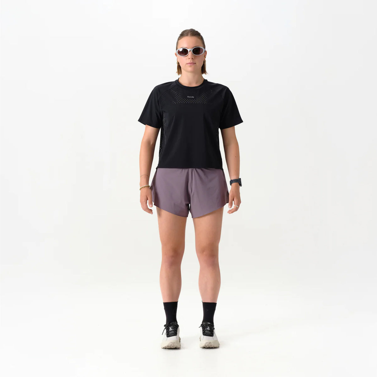 Women's Raide Thermal Dispersion Tee Black front full body view on female runner showing cool-to-touch Italian microfibre with four-way stretch and body-mapped perforations for lightweight warm weather training