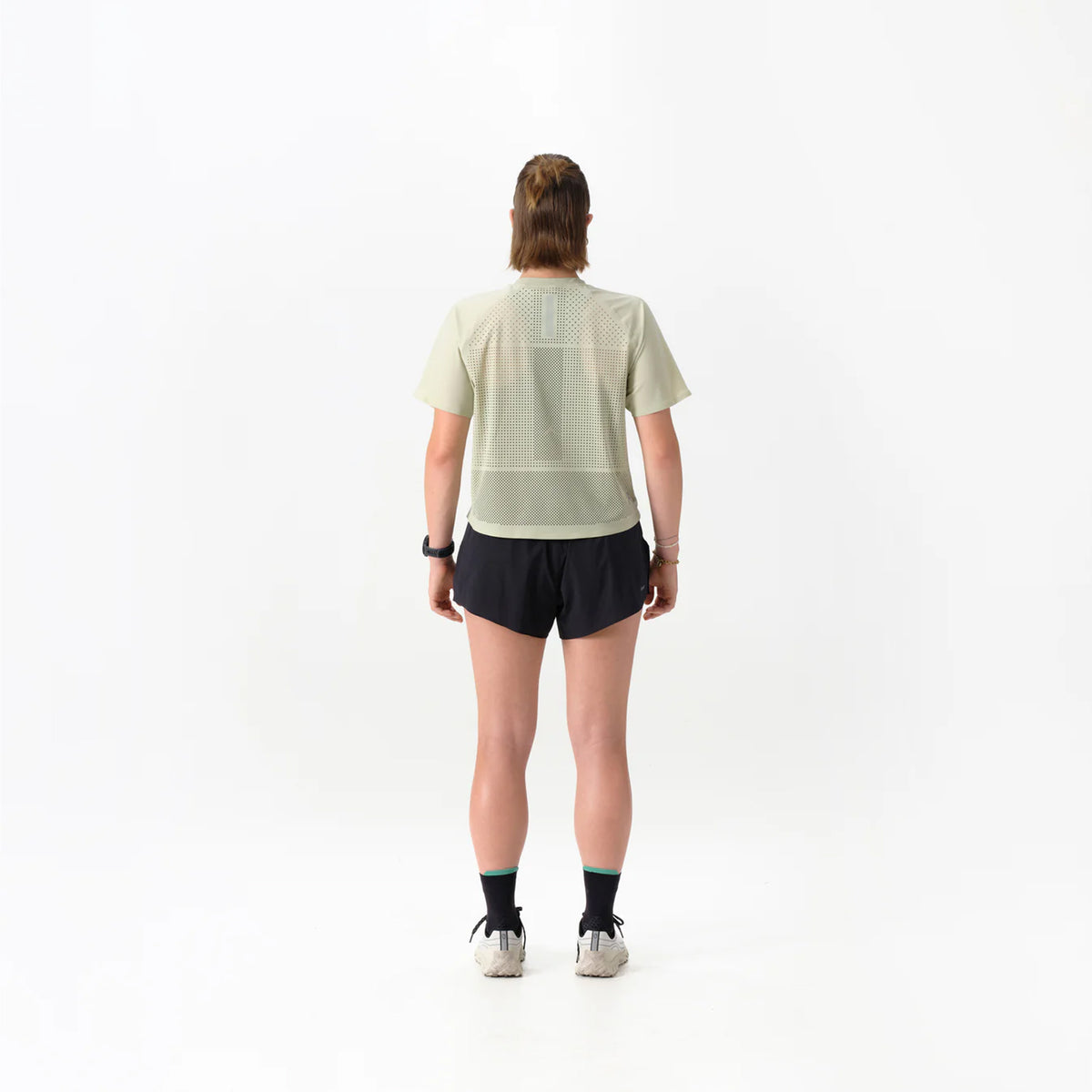 Women's Raide Thermal Dispersion Tee Lichen back full body view on female runner showing body-mapped centre back perforations with reflective branding and Italian-knit microfibre for evaporative cooling during road running