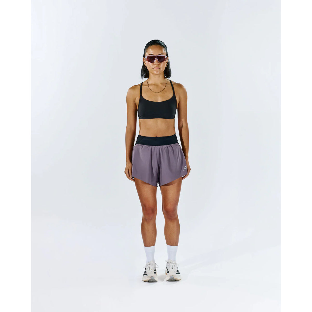Raide TrailTech Short women's in Dusk — full body front view worn on model showing 3 inch silhouette, laser-perforated waistband and pocket placement in motion on trail
