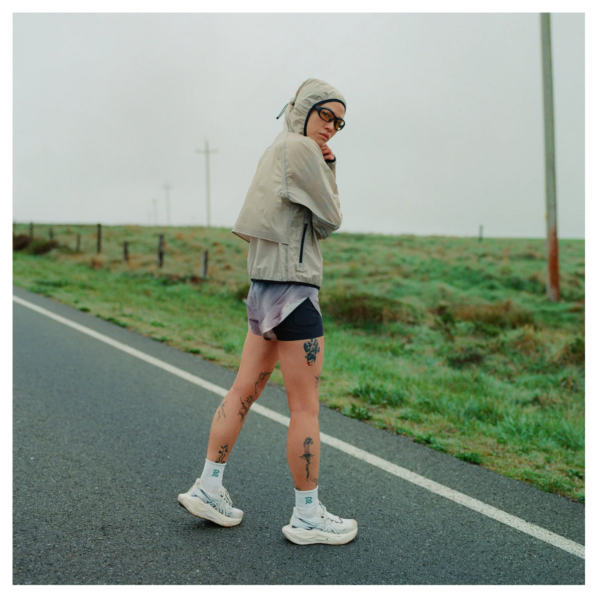 Women's Bandit VeloRip Ultralight Windproof Jacket Oatmeal lifestyle shot on female runner showing packable windproof water-repellent jacket with PFC-free finish for on-the-go weather protection