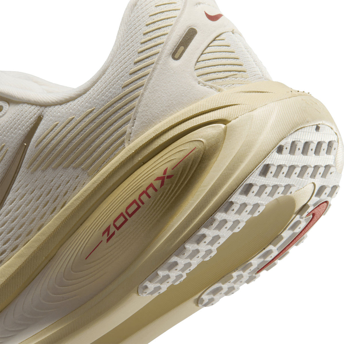 Women's Nike Vomero 18 Running Shoes Sail Metallic Gold Grain Light Khaki Filbert angled side and heel view showing maximum cushioned platform with breathable upper and durable outsole for plush comfortable daily road running
