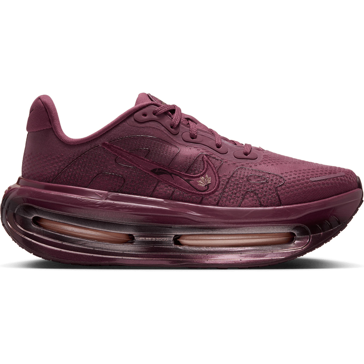 Nike Women’s Vomero Premium GG Running Shoes in Pink Smoke / Mystic Dates, featuring a deep pink color, thick, sculpted ZoomX cushioning midsole, and a cut-out section with an internal Air Zoom unit.
