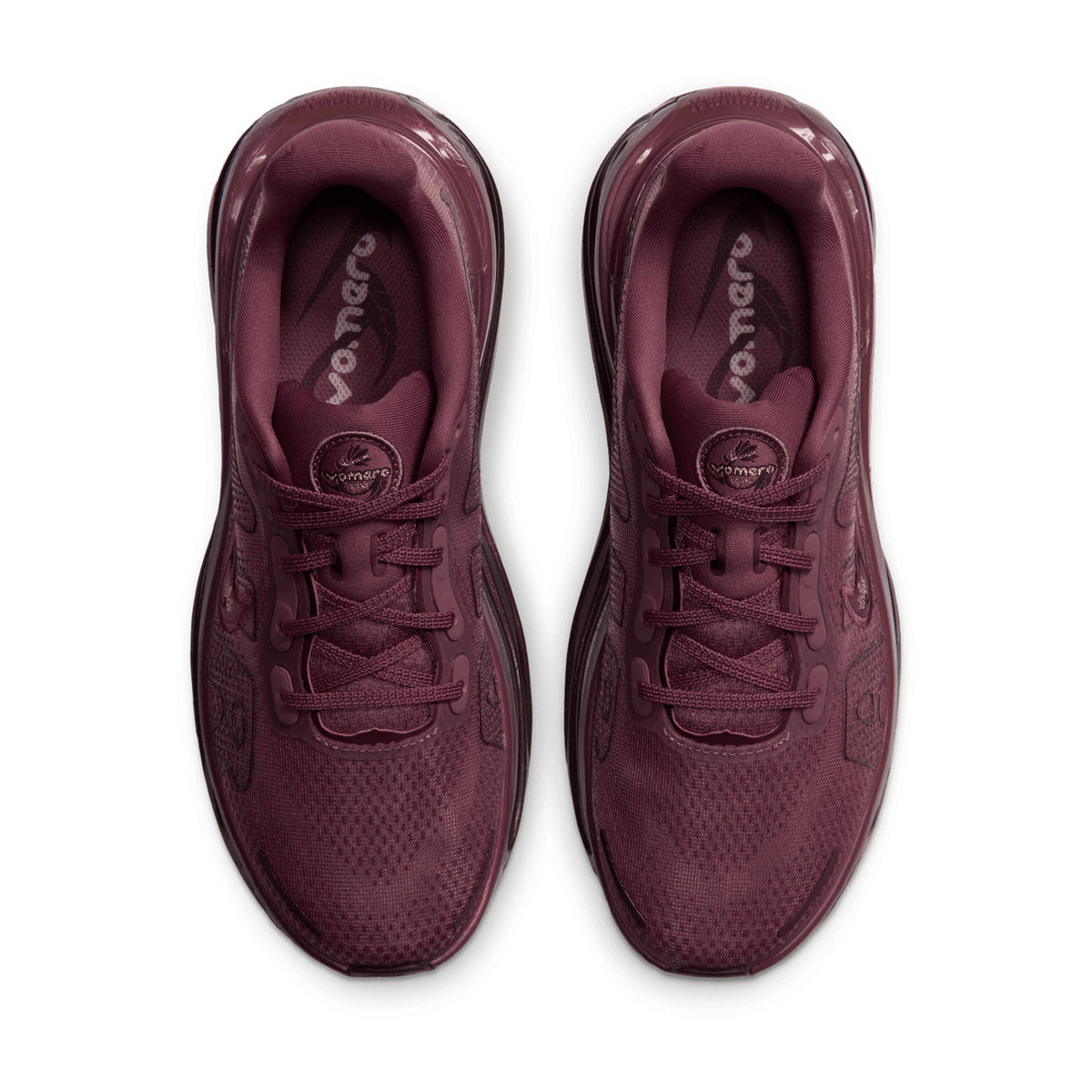 A pair of dark pink Women’s Vomero Premium GG Running Shoes viewed from directly above, showing laces and ZoomX cushioning insoles.