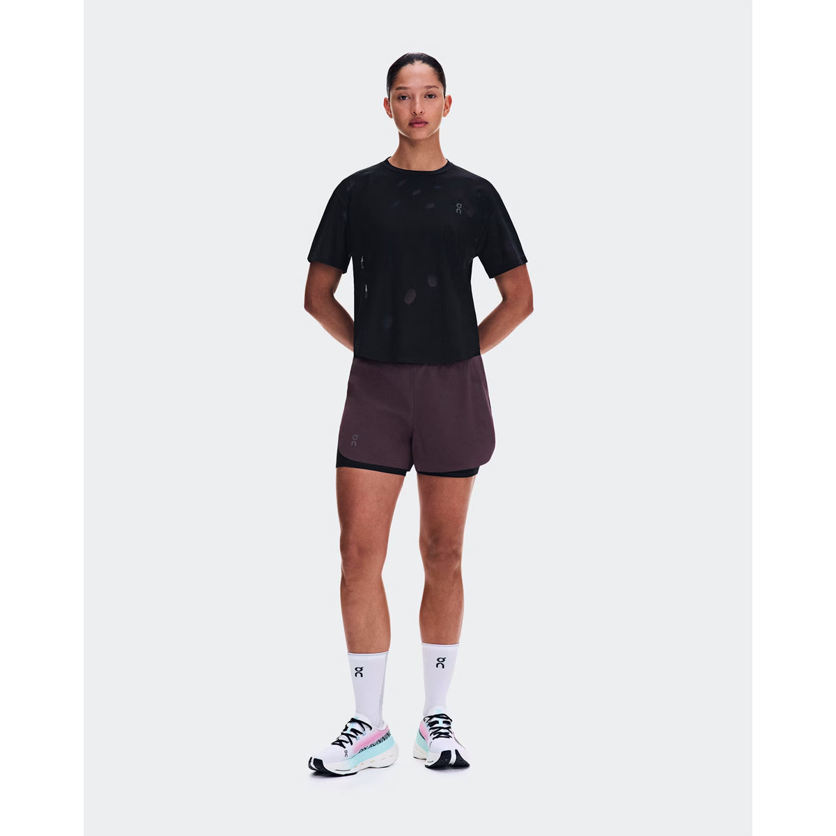 Women's On Zero-T Breathe Black front full body view on female runner showing ultralight OAC-inspired jacquard tee with DryTec breathable construction for comfortable training performance