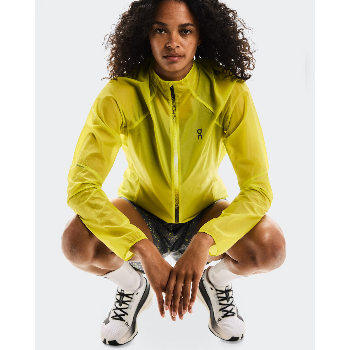 Women's On Zero Jacket Lime close-up front showing spiral dart elbow construction for enhanced arm mobility and featherlight water-repellent fabric