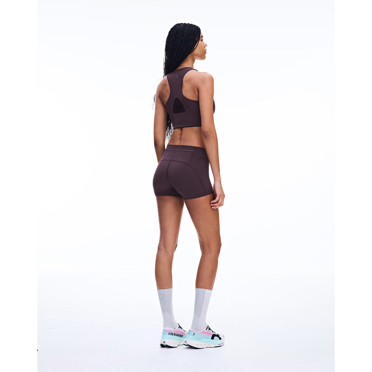 Women's On Zero Short Tights Urchin back full body view on female runner showing back pocket gel storage with lightweight technical fabric and On athlete-inspired graphic for comfortable race day running