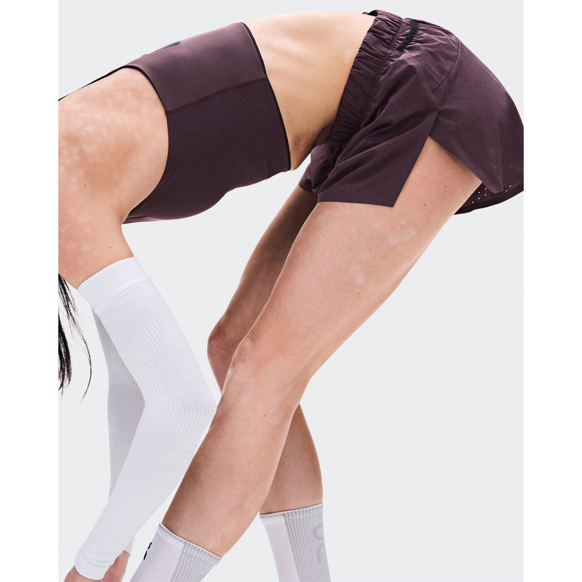 Women's On Zero Shorts Urchin side view on female runner showing ultra-lightweight stretch-woven perforated outer with soft-feel inner brief for comfortable ventilated race day running