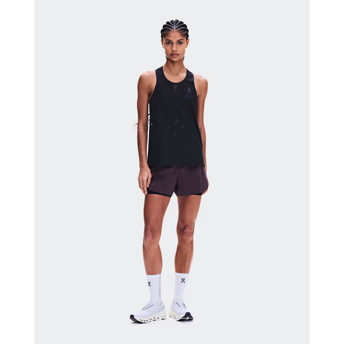 Women's On Zero Tank Breathe Black front full body view on female runner showing ultralight OAC-inspired jacquard tank with DryTec breathable construction for race day and fast training performance